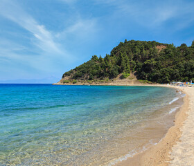 Aegean sea coast landscape, view from sandy beach (Chalkidiki, Greece). Peoples unrecognizable.