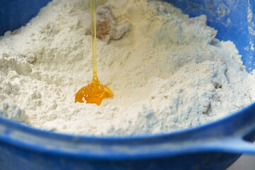 honey pours into flour