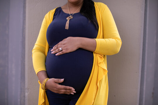 Black Woman Holding Pregnant Belly