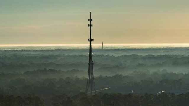 Aerial view of telecommunications cell phone tower with wireless communication 5g antennas for network signal transmission