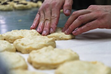 baker at work. The baker shapes the bread. Hands on the close-up form bread