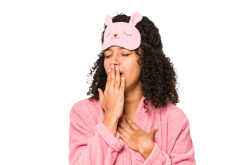 Young african american curly woman wearing a sleep mask isolated