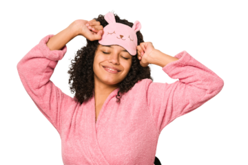 Young african american curly woman wearing a sleep mask isolated