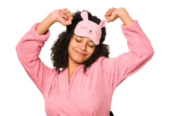 Young african american curly woman wearing a sleep mask isolated