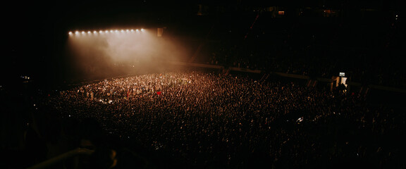 Aerial view of a massive crowd in a concert - obrazy, fototapety, plakaty