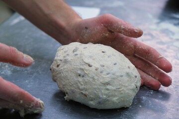 baker at work. The baker shapes the bread. Hands on the close-up form bread