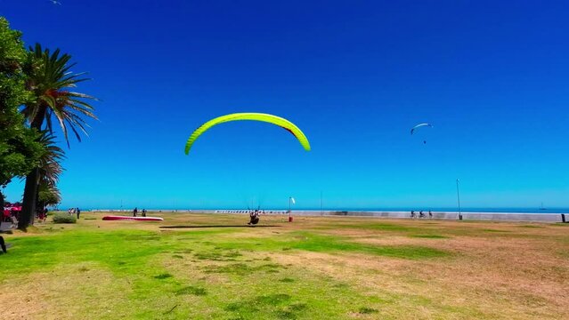 Paraglider landing on the beach. Cape Town, Sea Point