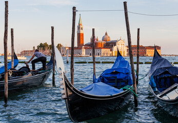 Panoramic view of gondolas at sunset, traditional on Grand Canal with San Giorgio Maggiore church. San Marco, Venice, Italy