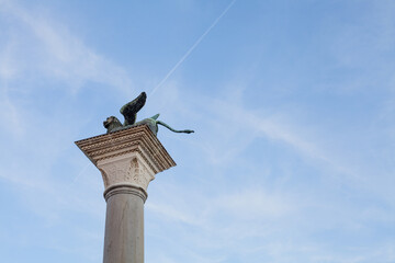 The Winged Lion of Venice on top of the column of San Marco, Venice - Italy)