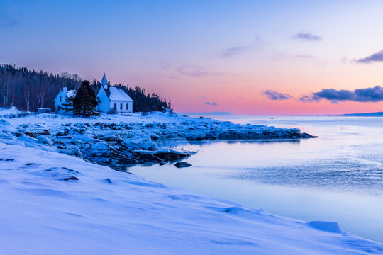 Charlevoix, sunrise over the chapel of Port-au-Persil, typical landscape of this region between hills and river.