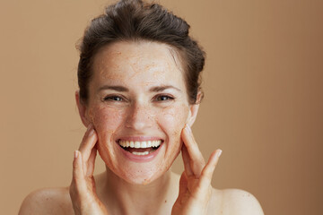 Portrait of smiling modern woman with face scrub