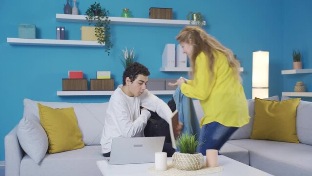 His mother helps the young man who is late for school.
Mother helps her son to get to school.
