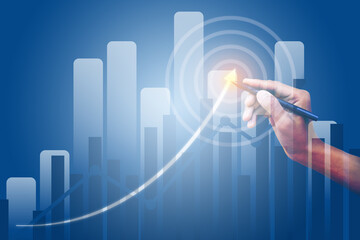 The businessman's hand holds a pen. The businessman's hand held a pen pointing at the target.