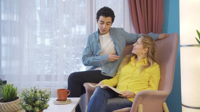 Cheerful and delightful mother and son. Reading books.
Mother and son reading a book together at home.
