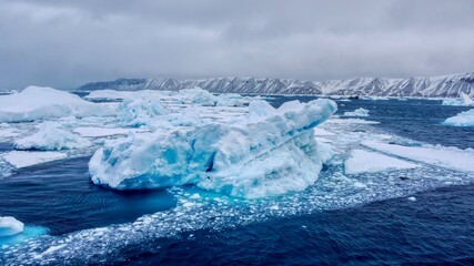 Wide angle view of a large area of icebergs floating in the sea off the coast of Snow Hill Island in the Admiralty Sound, Antarctica.