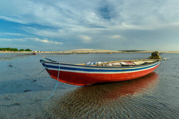 Naklejka premium Jericoacoara Beach, Ceará, Brazil on January 19, 2023. Fishing boats at low tide on the beach.