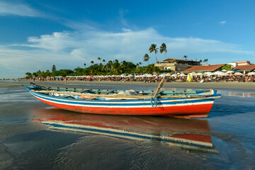 Fototapeta na wymiar Jericoacoara Beach, Ceará, Brazil on January 19, 2023. Fishing boats at low tide on the beach.