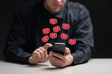 person holding a smartphone and receive the like in social network
