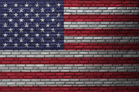 the graffiti of national flag of the usa painted on the rusty wall