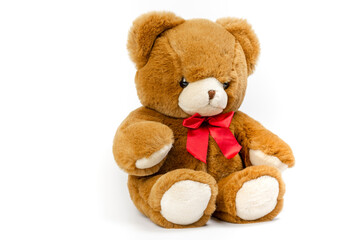 Cute Brown Teddy bear with a red ribbon on a white background. Plush toys for kids.