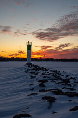 Lighthouse in frozen lake at sunset, Ontario, Canada