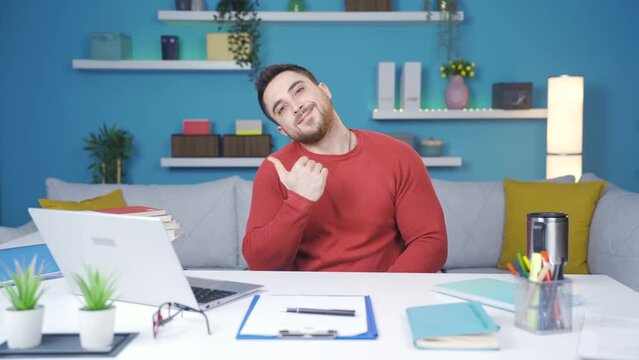 Young man showing how to exercise in the office. doing neck exercises.
Man working from home shows the camera how to do neck exercise step by step.
