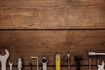 Flat lay with various work tools on wooden background working table. Top view on new hand tool set for repair, construction kit, overhead. Must-have for men. Equipment for building. Industry concept