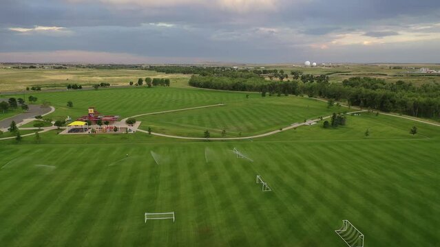 Aerial over vast green soccer fields at recreation center, Aurora, Colorado