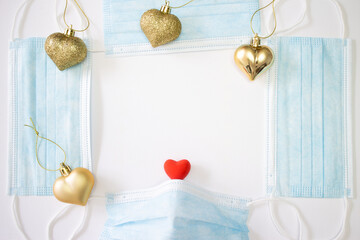 Blue Face masks Frame, gold Christmas heart balls, small red heart on white canvas. Health care and protection PM 2.5, Virus COVID-19. Safe Everyday during coronavirus pandemic and Air pollution