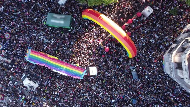 Multitude of people in Plaza de Mayo for march of LGBT Pride Parade, Buenos Aires in Argentina. Aerial top-down with speed ramping rising