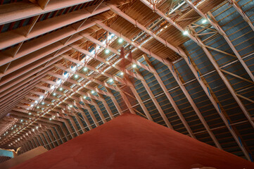 Pouring red phosphate fertilizers on pile in storehouse