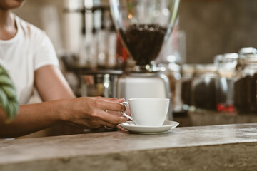 Barista serving a coffee to customer at the coffee shop.