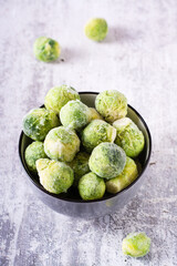 A bowl of frozen brussels sprouts on the table. Vegetable diet. Web banner. Vertical view