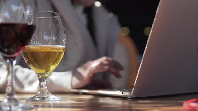 A woman works at a computer from a restaurant