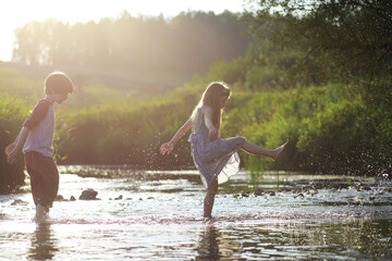 Children walk in the summer in nature. Child on a sunny spring morning in the park. Traveling with children.