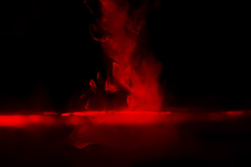 Red smoke over black studio background. Red steam on a black background. Copy space.
