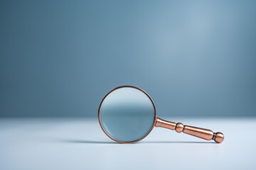 Close up magnifier glass on wooden table, the concept of searching or finding for an idea, Search...