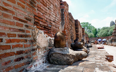 large stone buddha statue that has been broken and destroyed for many years Located inside an old temple historical park,buddha 