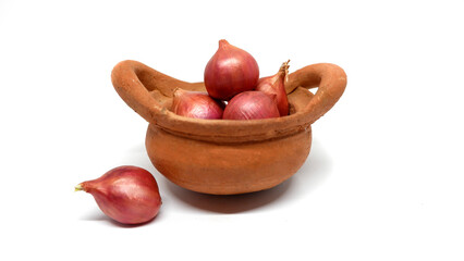 Shallots in a basket on a white background