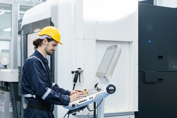 Man engineer using computer controlling cnc machine at workshop. professional male control...