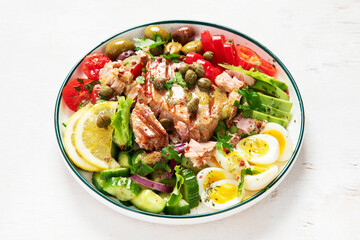 Tuna salad with lettuce, eggs and tomatoes.