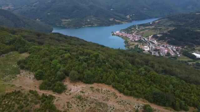 Aerial drone shot of Eugi swamp. Blue swamp surrounded by forest. The blue color of the water contrasts with the green of the trees.