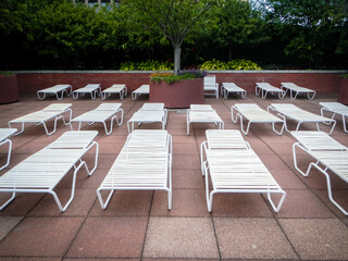 Bunch of empty beach chairs by pool side