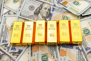 Closeup of gold bar and dollars