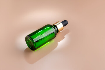 Cosmetic bottle serum or essential oil on beige background. Natural cosmetics concept, skin care product. Beauty concept for face body care. Mockup