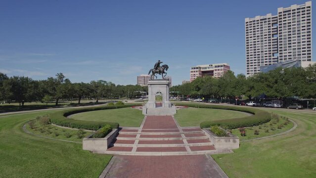 Aerial - Low shot of Sam Houston statue and reveal of background - Houston, TX