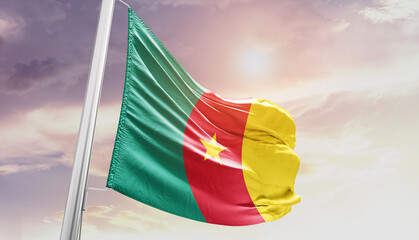Waving Flag of Cameroon in Blue Sky. The symbol of the state on wavy cotton fabric.