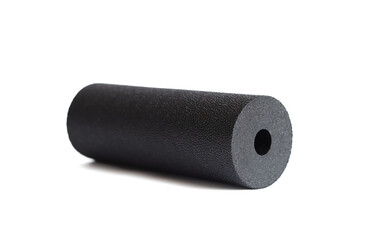 A black massage foam roller mini isolated on a white background. Close-up. Foam rolling is a self...