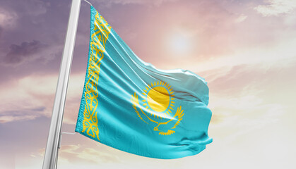 Waving Flag of Kazakhstan in Blue Sky. The symbol of the state on wavy cotton fabric.