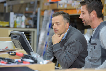boss and worker checking results on pc